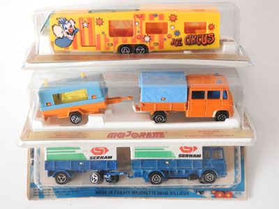 three toy trucks that are sitting on top of each other