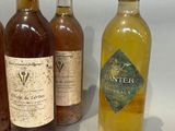 several bottles of wine are lined up on a table