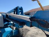 a blue crane that is parked in a parking lot