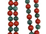 a close up of a necklace with red and green beads