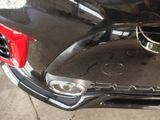 a close up of a car ' s front bumper with the hood up