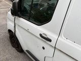 a white van parked in a parking lot next to a building