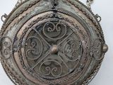 an antique silver pocket watch with a chain hanging from it