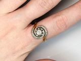 woman ' s hand with a diamond ring on it ' s finger