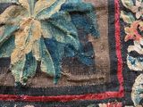 a close up of a rug with a flower design on it