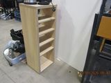 a wooden shelf with several shelves in a room