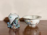 two small vases sitting on a table next to each other
