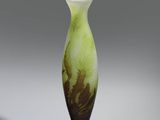 an image of a green and black vase sitting on top of a table