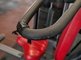 a red seat on a machine in a gym