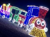un train décoré de guirlandes lumineuses, garé au bord de la route