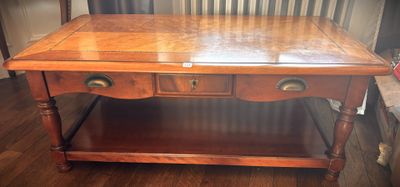 a wooden table with two drawers on top of it