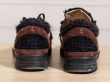 someone is wearing a pair of shoes that are on top of a table