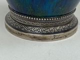 a blue vase sitting on top of a table