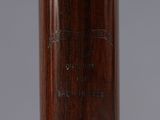 the baseball bat is made of wood and has a baseball cap on top of it