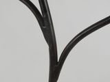 a close up of a metal tree with a black stem