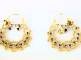 a pair of gold earrings with blue stones on them