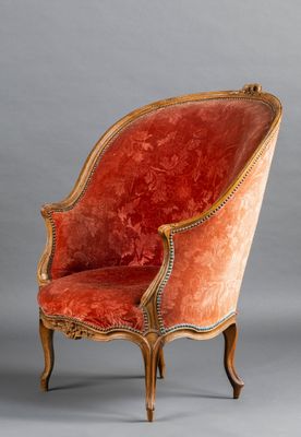 a red chair with gold trim and a red upholstered seat