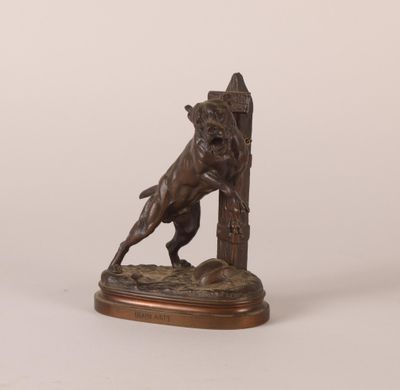 a bronze statue of a dog on a pedestal with a fire hydrant in the background