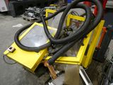 a machine that has a hose attached to it ' s side