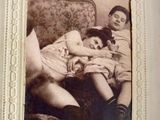 an old photo of two children sitting on a couch
