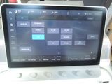 a tablet computer that is sitting on top of a washing machine