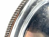 a close up of a silver plate on a table