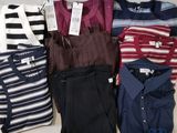 a lot of men ' s shirts and pants on the table