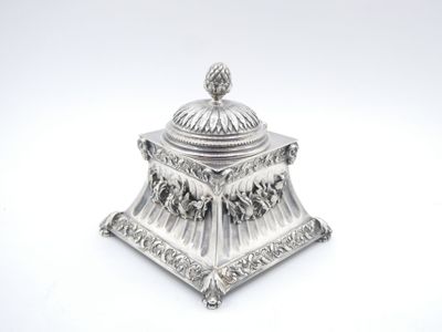 an antique silverplated sugar dish with a domed lid on a white background