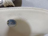 a close up of a purse with a button on it