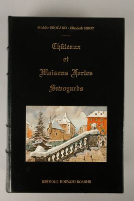 an old book with a picture of a town in the background