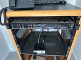 a laptop computer sitting on top of a computer stand