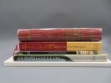 trois livres sont empilés les uns sur les autres sur une étagère