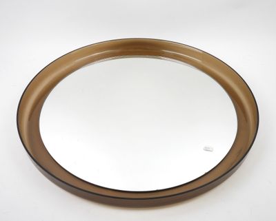 brown and white round mirror on a white surface