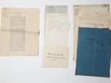 several pieces of old papers are on a white surface