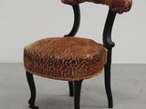 an image of a small chair with a red and orange upholstered seat