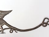 a bird that is sitting on top of a hook
