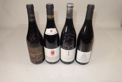 four bottles of wine are lined up on a counter