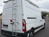 a white van parked in a parking lot with a ladder on the back of the van