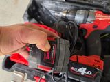 someone is holding a cordless drill in a tool case