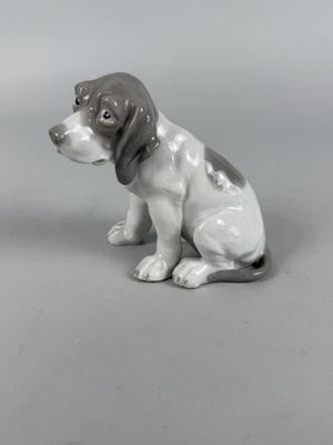 a figurine of a dog sitting on the ground
