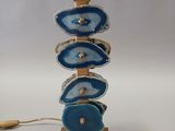 a blue and gold lamp that is on a table