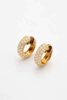a pair of gold and diamond hoop earrings