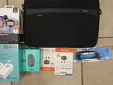 a black bag sitting on a tiled floor next to other items