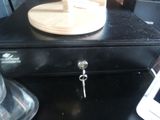 a black metal box with a key on top of it