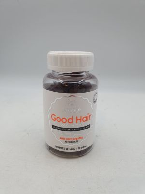 a close up of a bottle of good hair with a white cap