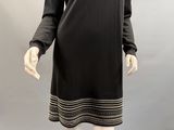 an image of a mannequin wearing a black dress with white stripes