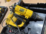 a yellow corded drill sitting on top of a black box