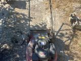 a red lawn mower that is sitting on the ground