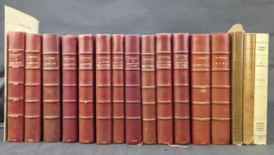 several old books are lined up in a row on a table