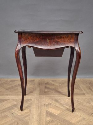 an old wooden table with a drawer on top of it